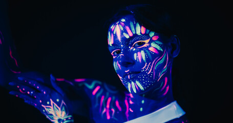 Creative Young Female Covered in Neon Body Paint Performing Modern Dance Choreography in a Studio with Abstract Art Background. Beautiful Contemporary Dancer Expressing Her Inner World Through Dance