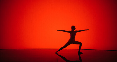 Fototapeta na wymiar Young Girl Engages in Peaceful Poses on a Digital Red Background, Channeling Inner Balance and Harmony with Graceful Movements and Tranquil Expressions. Cinematic Yoga Practice