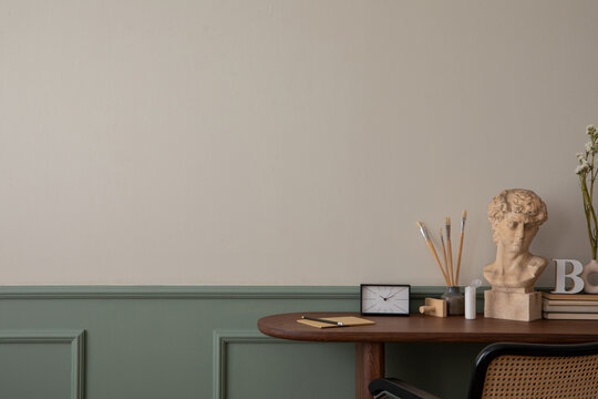 Minimalist composition of cozy office home interior with copy space, wooden consola, rattan armchair, decoration, school accessories, book and personal stuff. Home decor. Template.
