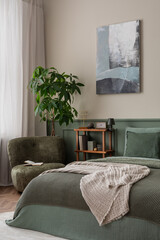 Interior design of bedroom interior with mock up poster frame, wooden sideboard, sage bedding, beige plaid, plants, books, lamp, sculpture, armchair and personal accessories. Home decor. Template.
