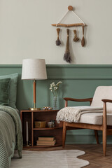 Interior design of cozy bedroom interior with mock up poster frame, bed, sage bedding, beige plaid,...