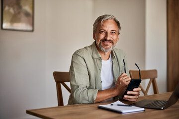 Portrait of a handsome senior man at the home office.