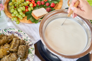 Cut with a knife, separate the serum. Master class and cheese tasting. Women make cheese. The...