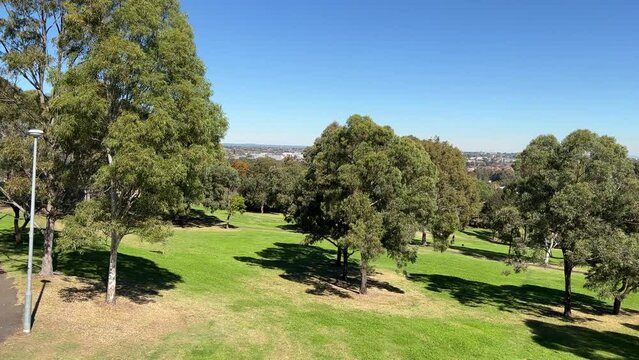 180 degree view of a Suburban western Sydney Park in NSW Australia trees walking trails and kids playground and houses in the horizon 
