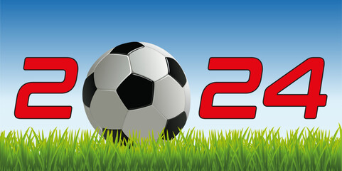 L’année 2024 avec un ballon de football posé sur la pelouse d’un terrain pour symboliser le lancement de la nouvelle saison de compétition. - obrazy, fototapety, plakaty