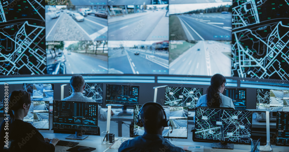 Poster Dark Monitoring Room with Multiethnic Specialists Monitoring Surveillance Feeds and Coordinating Traffic Operations on Desktop Computers. Employees Working in High-Tech Office with Multiple Screens