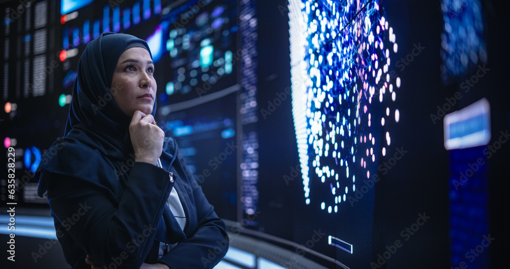 Poster Portrait of a Thoughtful Middle Eastern Software Developer Working in Technological Corporate Office. Young Woman Testing Artificial Intelligence Algorithms for an Innovative Internet Project