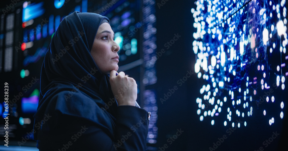 Fototapete Portrait of a Thoughtful Middle Eastern Software Developer Working in Technological Corporate Office. Young Woman Testing Artificial Intelligence Algorithms for an Innovative Internet Project