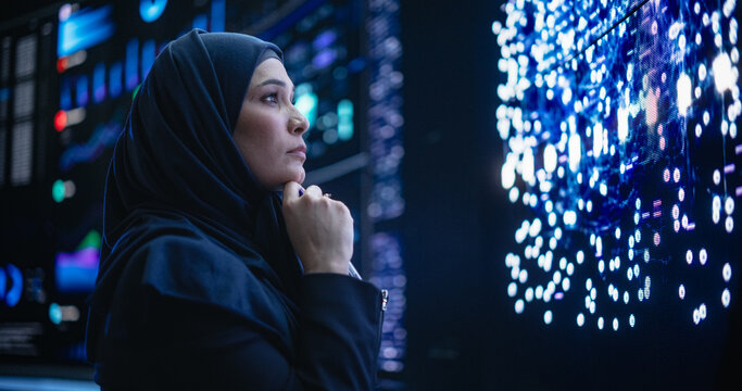 Portrait of a Thoughtful Middle Eastern Software Developer Working in Technological Corporate Office. Young Woman Testing Artificial Intelligence Algorithms for an Innovative Internet Project
