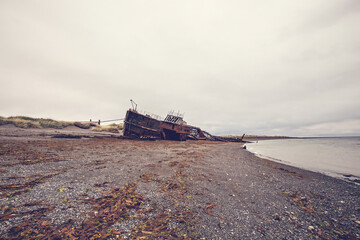 Shipwreck called Amadeo on the  coast of Magellan Strait, rusty warship wreck, Tierra Del Fuego,...