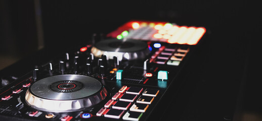 Fototapeta na wymiar DJ controller close up view in live performance night club dance music.