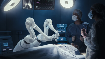 Two Surgeons Observing High-Precision Programmable Automated Robot Arms Operating Patient In...