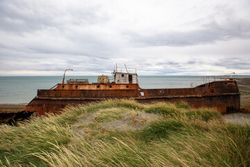 Shipwreck called Amadeo on the  coast of Magellan Strait, rusty warship wreck, Tierra Del Fuego,...