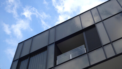 Modern apartment buildings on a sunny day with a blue sky. Facade of a modern glass building