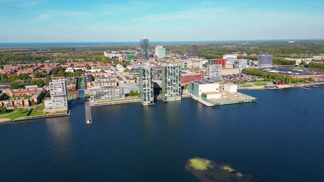 Aerial View on Skyline of Almere Netherlands, panning around. Almere was established in the mid-1970s and is currently the 7th largest city in The Netherlands.