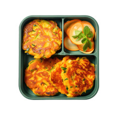 Carrot and zucchini fritters in a lunchbox top view isolated on transparent background. Generative AI