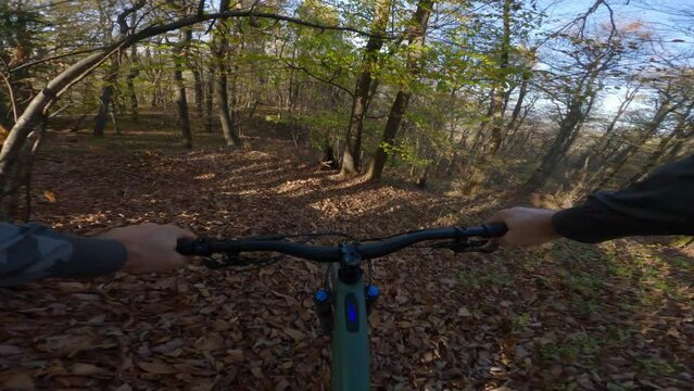 POV shot of e bike going uphill in the forest, mountain bike MTB