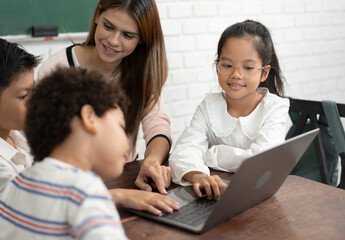 Obraz premium Happy student Asia kid girl learning with friend and teacher in classroom 