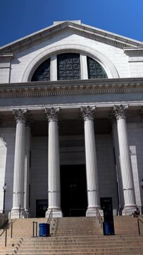 Vertical video push into the Smithsonian Museum of Natural History in Washington, DC with a clear blue sky.