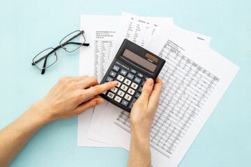 Office table with financial accounting and business planning with calculator - obrazy, fototapety, plakaty