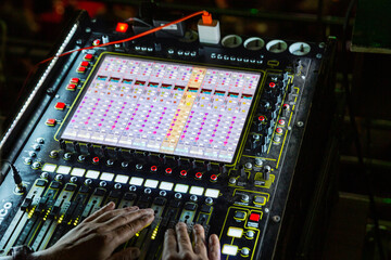 Hands on mixing console in music recording studio