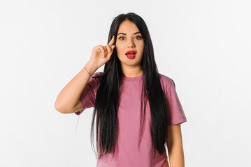 Young serious and confident brunette woman, looking thoughtful, having an idea, standing in trendy...