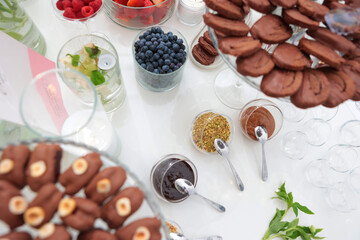 Assortment of sweet sauces. Various sauces and toppings for dishes. Desserts are on the table. The concept of public catering.