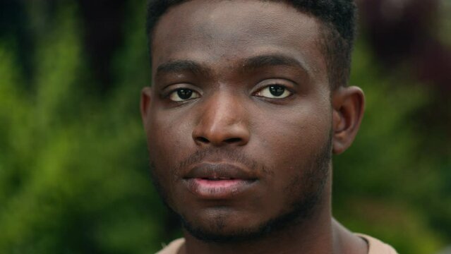 Close up male face serious millennial young African American ethnic guy handsome portrait sad calm strong man in city outdoors looking at camera posing outside businessman student headshot traveler