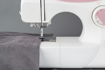Sewing machine, stitching fabrics, needle in a round plan