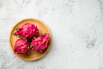 Ripe red dragon fruit on stone table