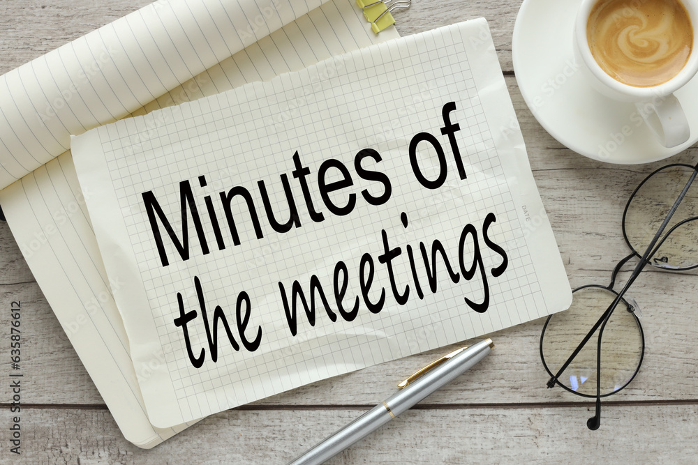 Poster minutes of the meetings close-up on a notebook from the top. text on a torn page. plant in the pot