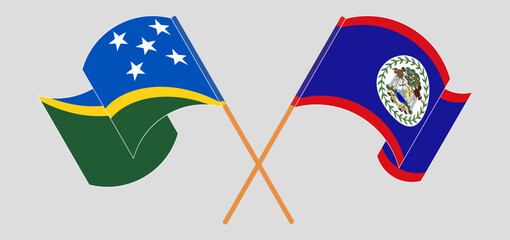 Crossed and waving flags of Solomon Islands and Belize