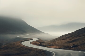 A curvy road in the misty mountains. Scenic fog landscape. Dreamy travel concept.