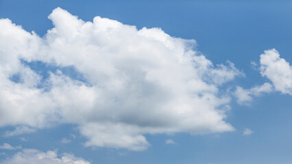 Naklejka na ściany i meble White clouds on blue sky, weather concept