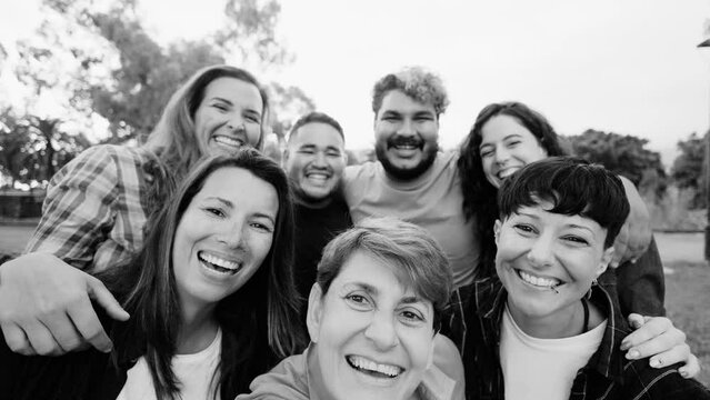 Multicultural people having fun together at park city - Happy group of friends taking selfie picture outdoors - Friendship and international community concept - Black and white editing