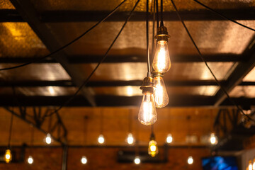 Classic style ceiling lighting bulbs during glowing in warm light shade, interior decoration object...