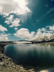 landscape of snowy mountains with a lake in the sierra nevada in spain