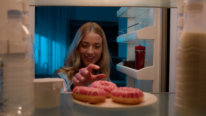 Point of view POV from inside refrigerator hungry Caucasian woman girl at night evening kitchen...
