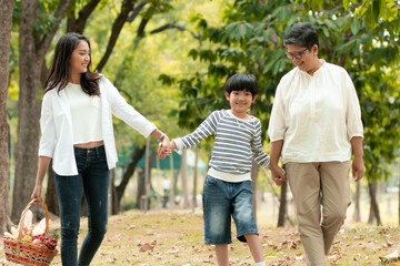 Happy Asian family spending time together outside in green nature and park, vacation of parents concept.