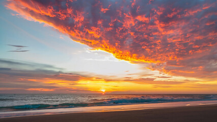 Fototapeta na wymiar Orange sunset over the beach