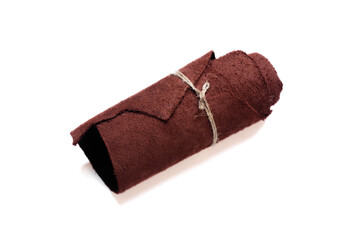 Leather rolled up piece isolated on white background. Top view.