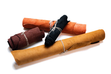 Leather rolled up pieces isolated on white background. Top view.