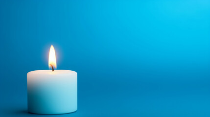 Fototapeta na wymiar burning candle on blue background