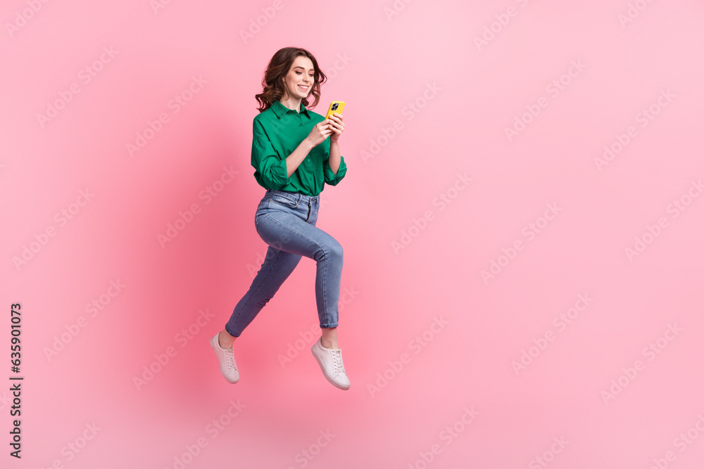 Poster full length portrait of active charming person jumping running empty space use smart phone isolated 