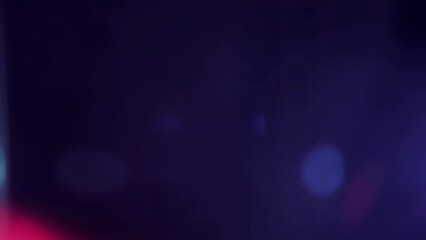 Lens flare and light leaks with bokeh from blinking flashing lights of special services, blue on right, red on left, with black background. Video overlay, looping.