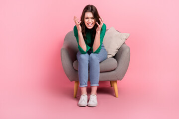 Obraz na płótnie Canvas Full length portrait of outraged disappointed crazy person sit chair scream raise hands isolated on pink color background