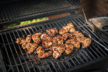 Chicken wings on the barbecue grill close up background.