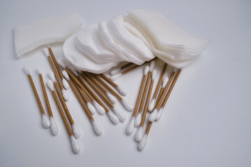Bamboo cotton buds and cotton pads on a colored background. Biodegradable ear plugs. Eco product