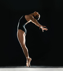 Art, ballet and woman on black background in dance performance with balance, stretching and talent....