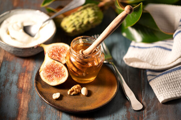 Delicious Greek honey from Rhodes with figs and bowl of yogurt